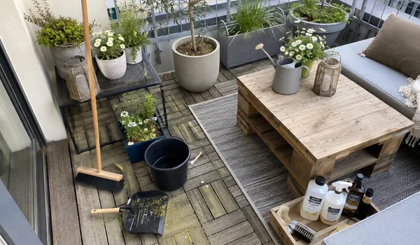 Cleaning tools on a timber balcony. We schedule maintenance so the oil has time to dry before the weekend.